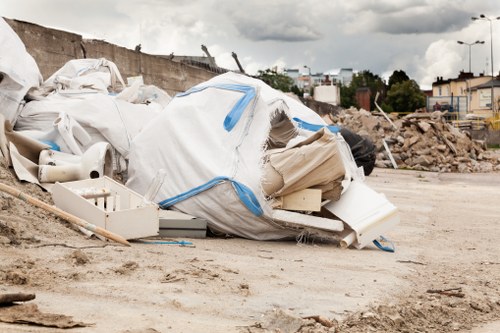 Front view of a skip on a Brixton street near market stalls