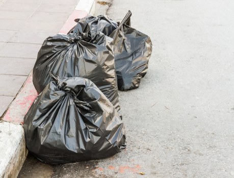 Van loading waste in a residential Brixton terrace area