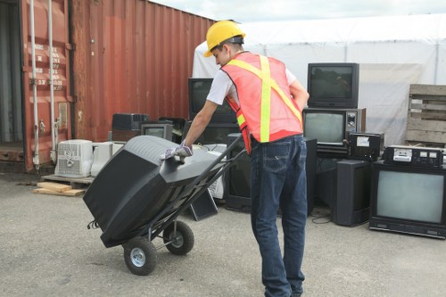 People responsibly disposing of waste in a skip